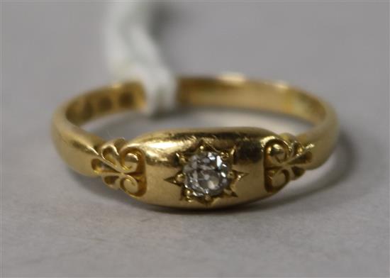 A Victorian 22ct gold and single stone diamond ring with carved shoulders, size P.